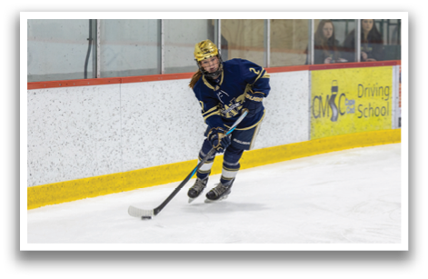A female ice hockey player is on the ice, holding a stick and preparing to shoot the puck. AI generated content