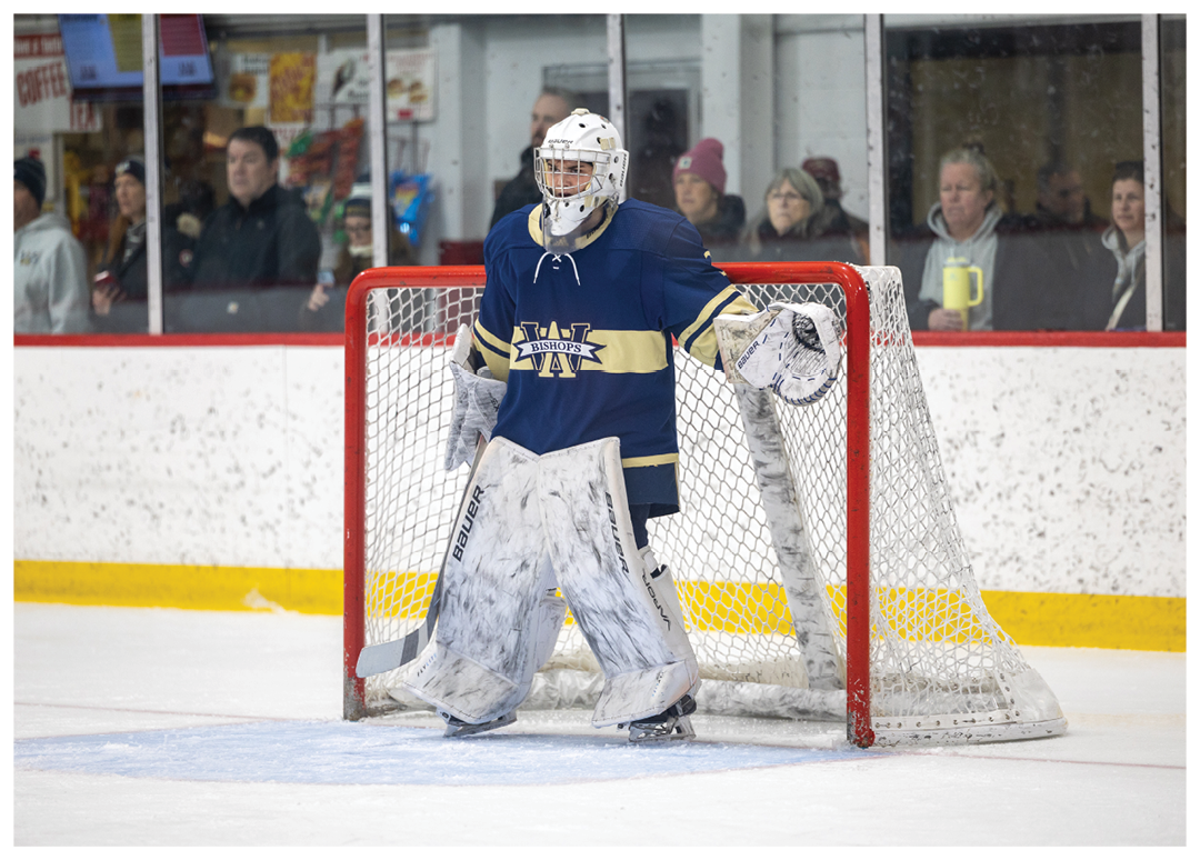 A hockey goalie is standing in front of a red net, wearing a blue and white uniform. AI generated content