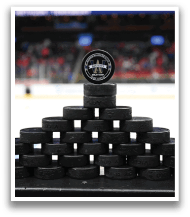 A stack of black and white hockey pucks on a black surface. AI generated content
