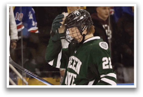 A hockey player with a green jersey and the number 22 on it is holding his helmet. AI generated content