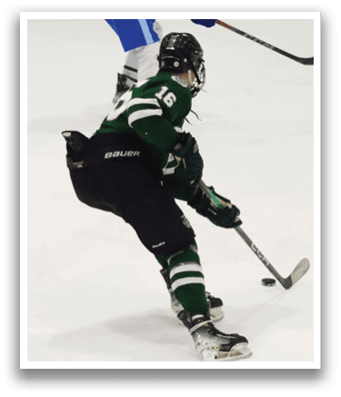 A hockey player in a green and white uniform is on the ice, holding a hockey stick and preparing to shoot the puck. AI generated content