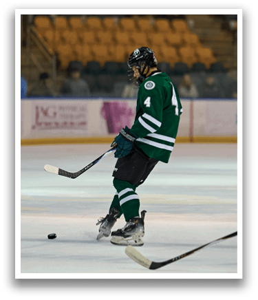 A hockey player in a green uniform is standing on the ice with his skates on. AI generated content
