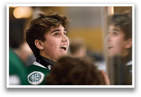 A young man wearing a green shirt is smiling and looking at the camera. AI generated content