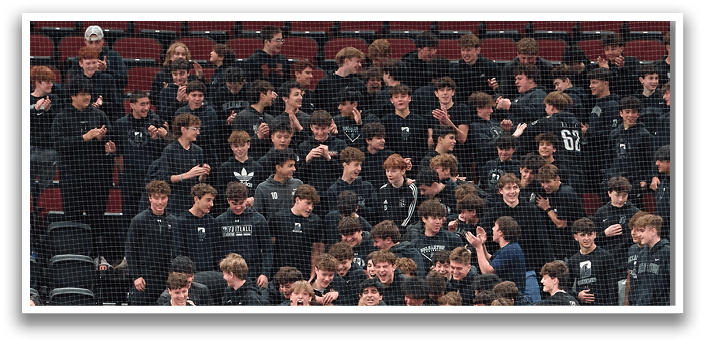 A group of people are gathered in a hockey rink, with some players standing on the ice and others sitting on the bench. The players are wearing black and white uniforms, and some are holding hockey sticks. The scene appears to be a mix of players and spectators, with some players standing close to the fence and others sitting on the bench. The atmosphere seems to be lively and energetic, with everyone engaged in the event. AI generated content