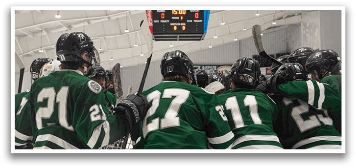 A group of hockey players huddled together on the ice, wearing green and white uniforms. AI generated content