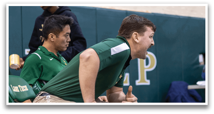 A man in a green shirt is sitting on a chair with his hands on his knees. AI generated content