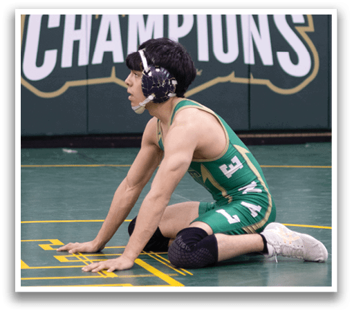A man wearing a green and white uniform is kneeling on the ground. AI generated content