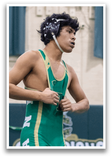 A man wearing a green and gold wrestling uniform is adjusting his shirt. AI generated content