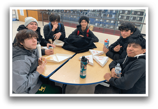 A group of young men are sitting around a table eating pizza and drinking water. AI generated content