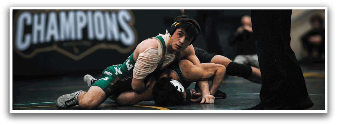 Two wrestlers are on the ground, one on top of the other, in a wrestling match. AI generated content