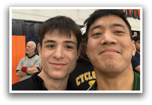 Two men are posing for a picture. One man is wearing a black shirt and the other is wearing a green shirt. AI generated content