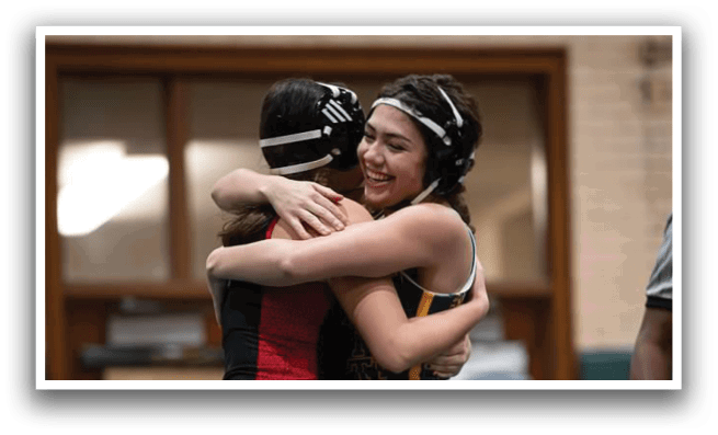 Two female athletes hugging each other in a gym. AI generated content