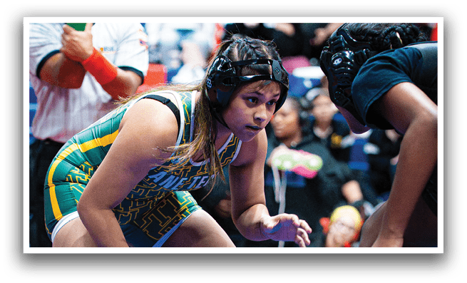 A female wrestler is in a defensive stance, wearing a green headband and a yellow and black uniform. She is surrounded by other wrestlers, some of whom are wearing headbands. The scene takes place in a gymnasium, with a bench visible in the background. AI generated content
