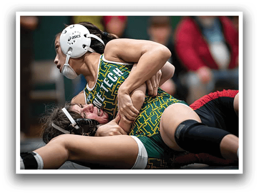Two girls wrestling on a mat, one girl is on top of the other. AI generated content