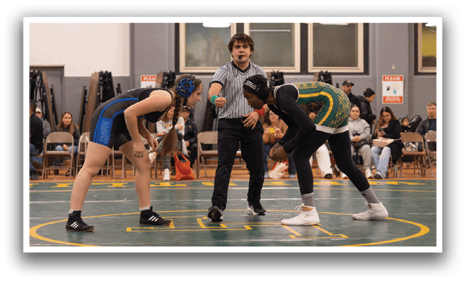 Two wrestlers are in the middle of a match, with a referee standing between them. The wrestlers are wearing black and blue uniforms, and the referee is wearing a striped shirt. The wrestlers are holding each other down on the ground, while the referee watches closely. AI generated content