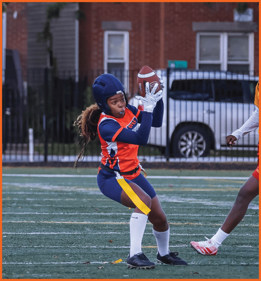 A football player running with a football. Description generated by AI