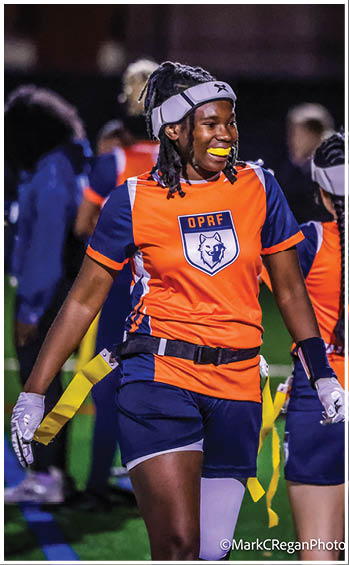 A football player running on the field. Description generated by AI