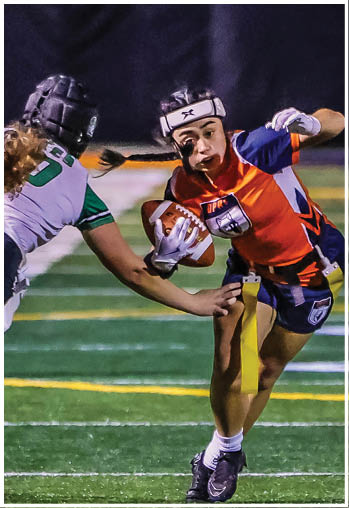 A football player running on the field. Description generated by AI