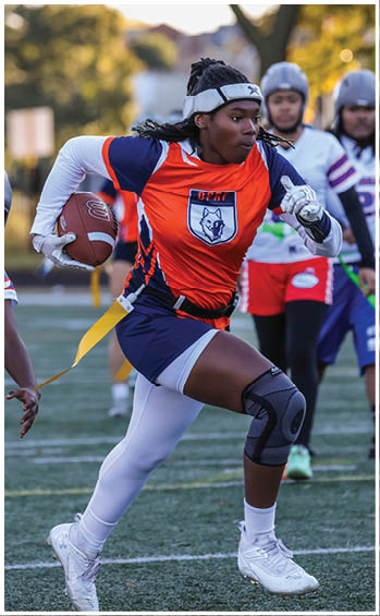 A football player running on the field. Description generated by AI