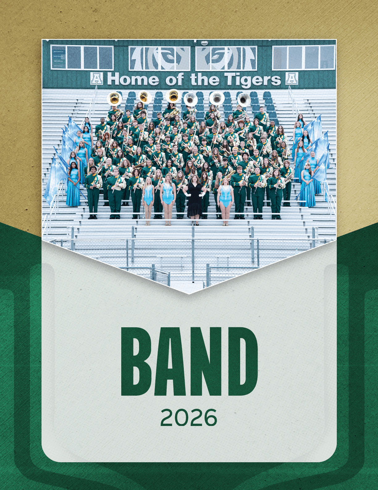 A large group of people in green uniforms and blue outfits are arranged in rows on bleachers with musical instruments and flags under a scoreboard that reads Home of the Tigers, with the word BAND and the year 2026 below the photo. Description generated by AI