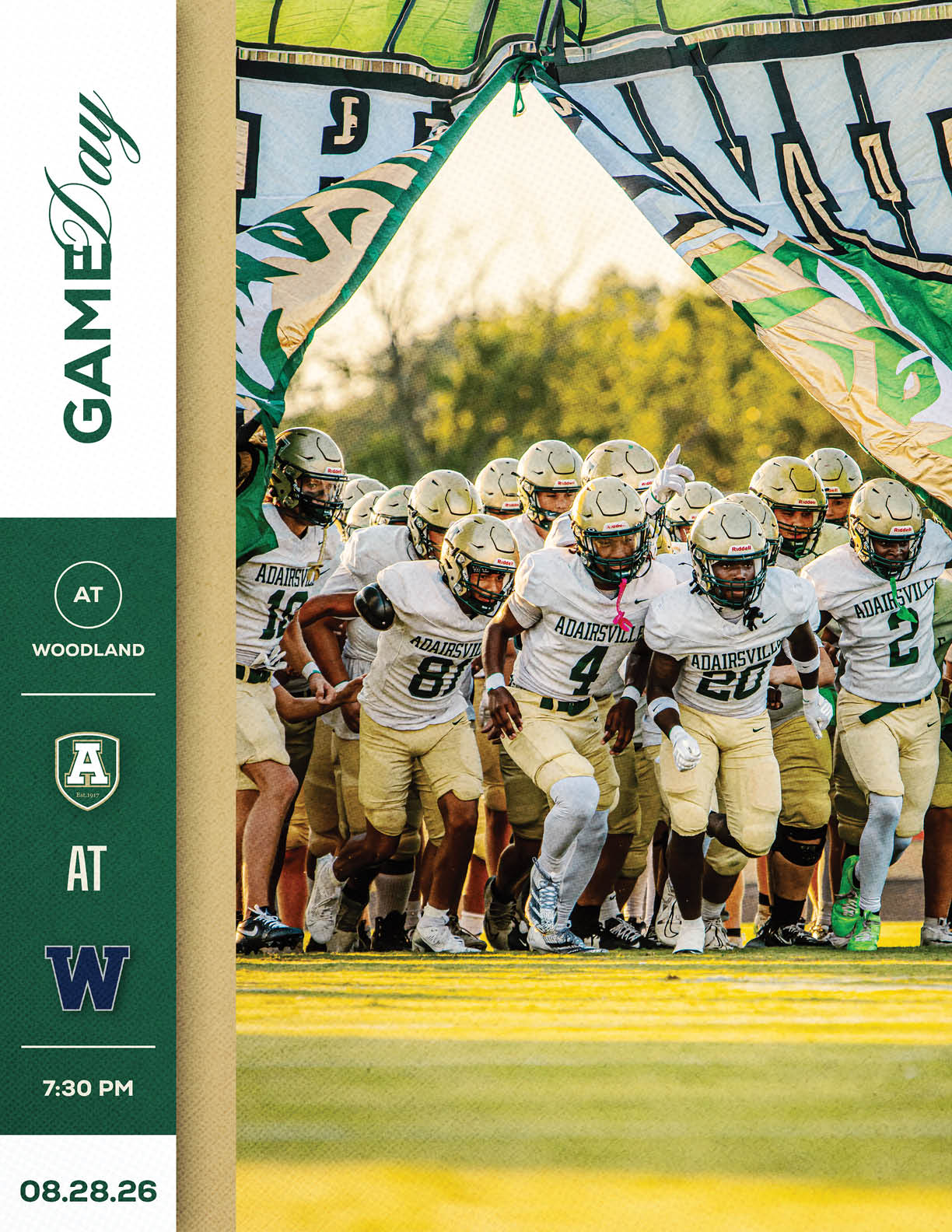 A group of football players in white and gold uniforms are running onto the field through a torn banner during a game day event. Description generated by AI