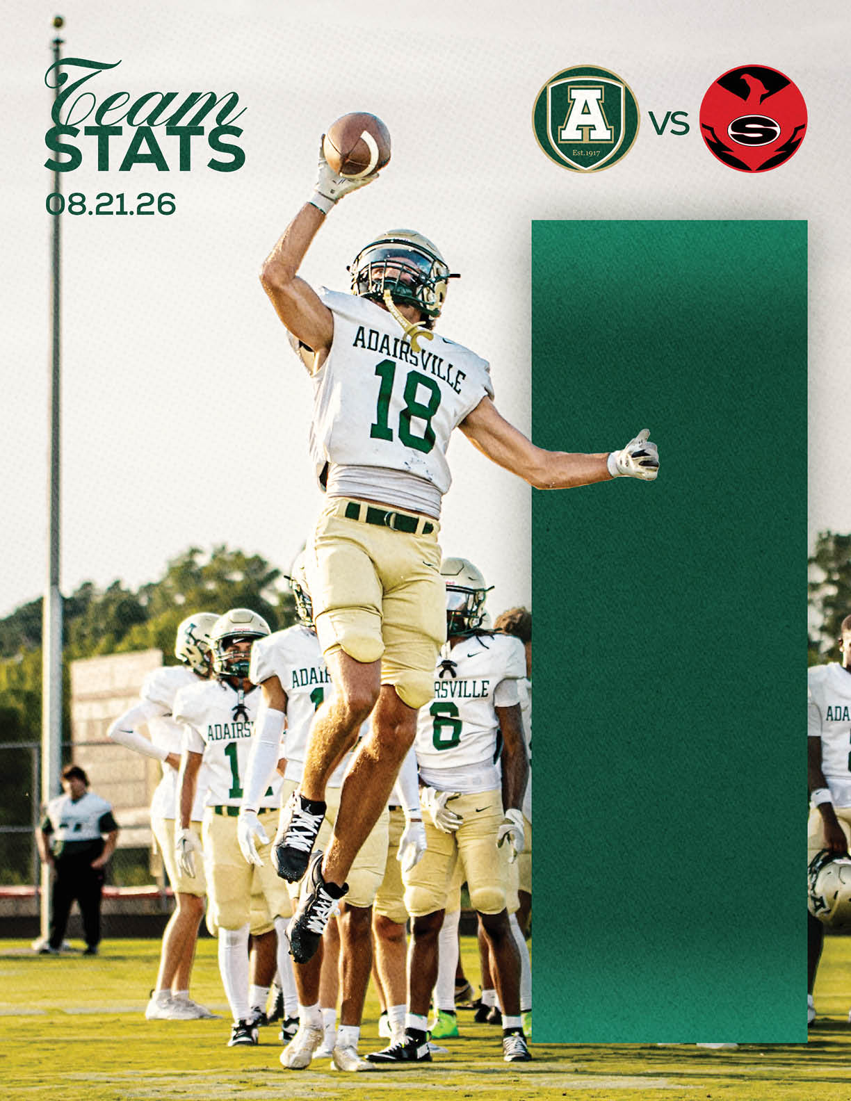 A person in a football uniform with the number 18 is jumping and holding a football while other players in similar uniforms stand in the background on a field with a scoreboard graphic showing a matchup between two teams. Description generated by AI