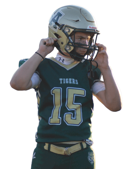A person wearing a gold football helmet with a large letter A on the side is looking to the right. Description generated by AI