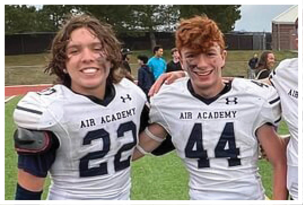 Four football players pose for a photo on the field. AI generated content