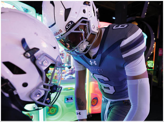 A football player wearing a blue and white uniform. Description generated by AI