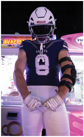 A football player catching a ball. Description generated by AI