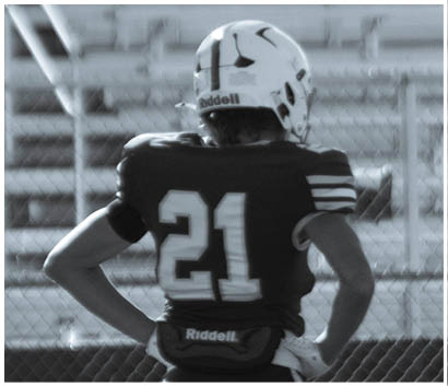 A football player running on the field. Description generated by AI