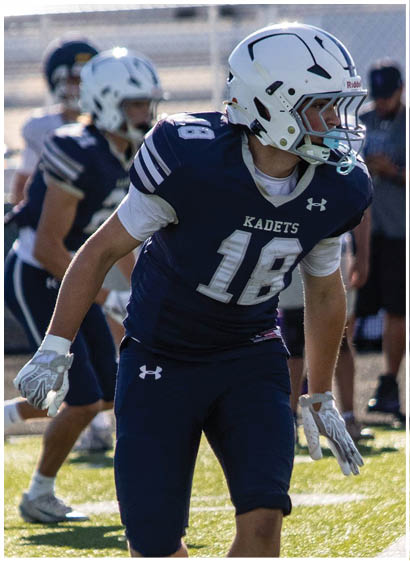 A football player wearing a blue jersey with the number 58 on it. Description generated by AI