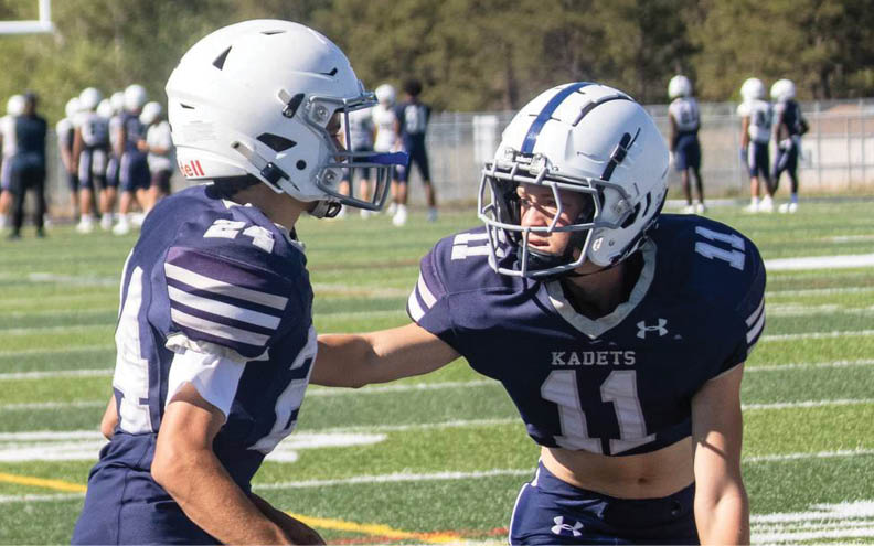 A football player wearing a blue and white jersey with the number 11 on it. Description generated by AI