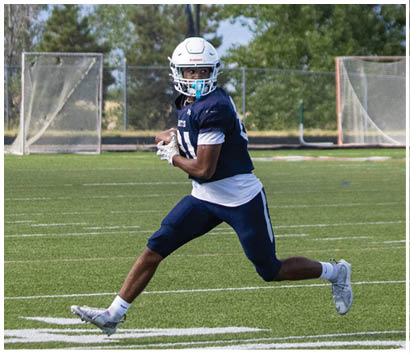 A football player running on the field. Description generated by AI