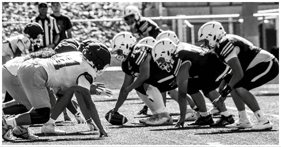 A football player is sliding on the ground. Description generated by AI