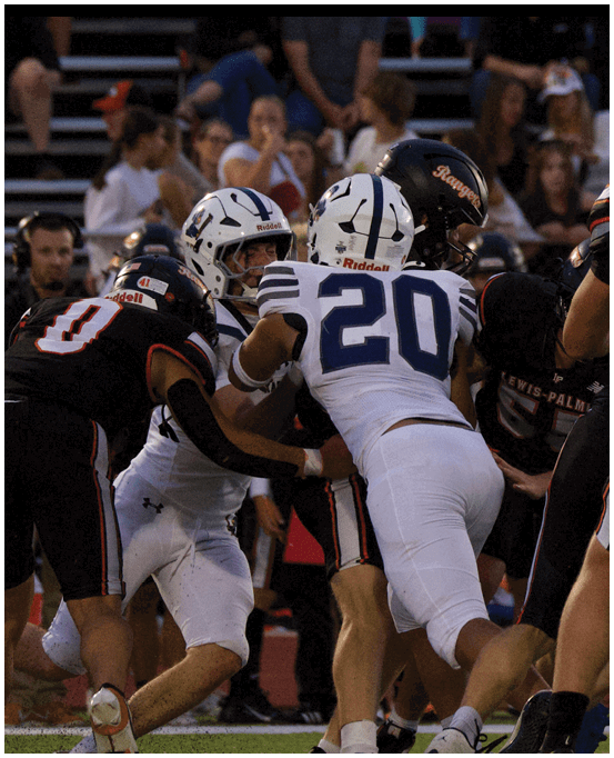 A group of football players wearing black and white uniforms. Description generated by AI