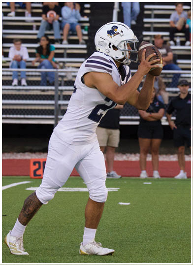 A football player wearing a blue jersey with the number 58 on it. Description generated by AI