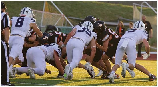 A group of football players on a field. Description generated by AI