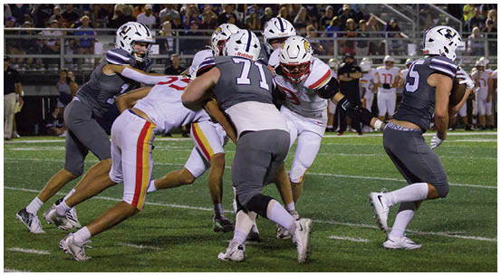 A group of football players on a field. Description generated by AI