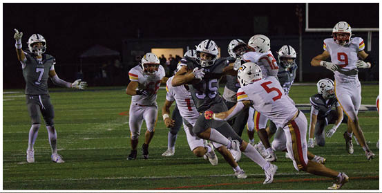 A football player is sliding on the ground. Description generated by AI