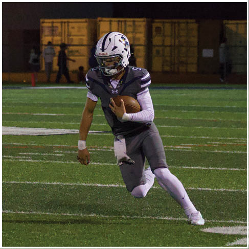 A football player running on the field. Description generated by AI