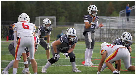 A group of football players on a field. Description generated by AI