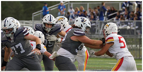 A football player is sliding on the ground. Description generated by AI