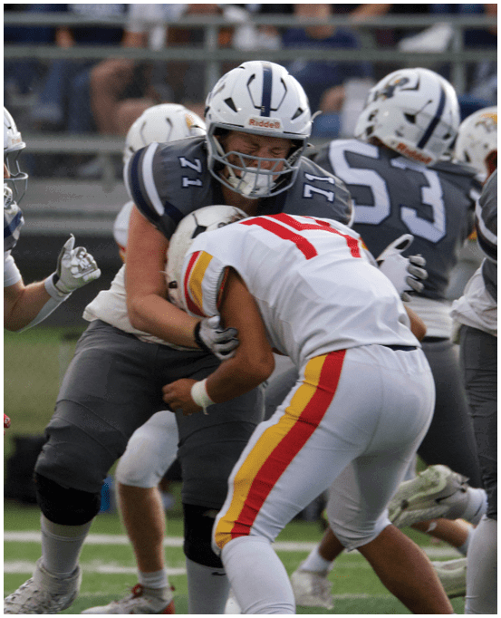 A group of football players wearing black and white uniforms. Description generated by AI