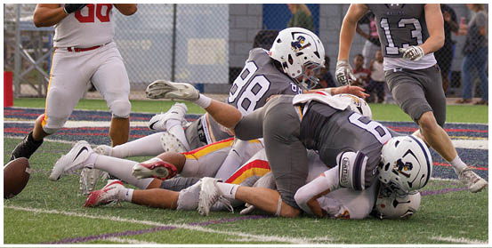 A football player is sliding on the ground. Description generated by AI