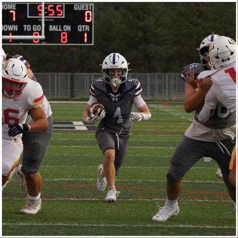 A football player running on the field. Description generated by AI