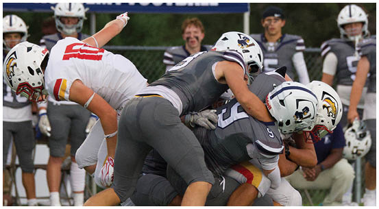A group of football players on a field. Description generated by AI