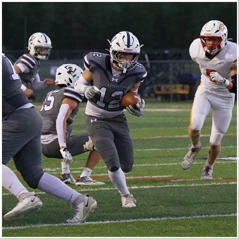 A football player running on the field. Description generated by AI