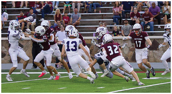 A group of football players on a field. Description generated by AI