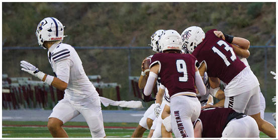 A football player is sliding on the ground. Description generated by AI